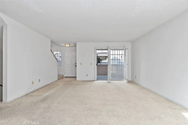 a view of an empty room with a fireplace