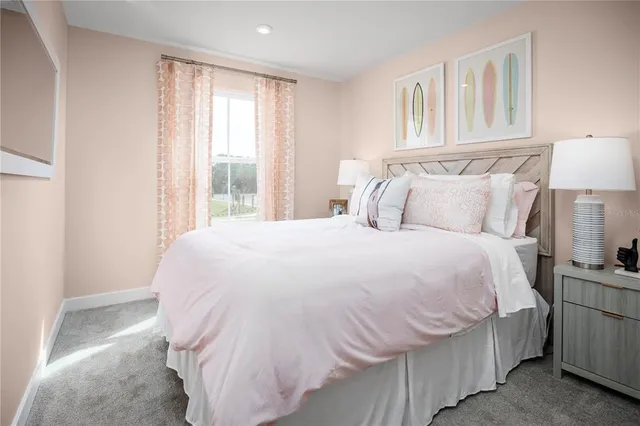 a bedroom with a bed and a lamp