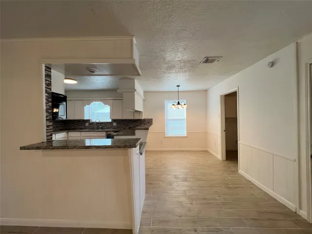 a kitchen with a refrigerator stove and microwave