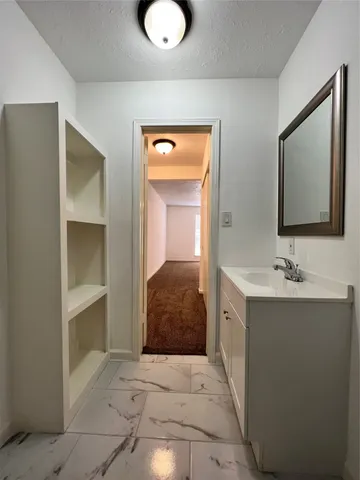 a view of room with window and hallway