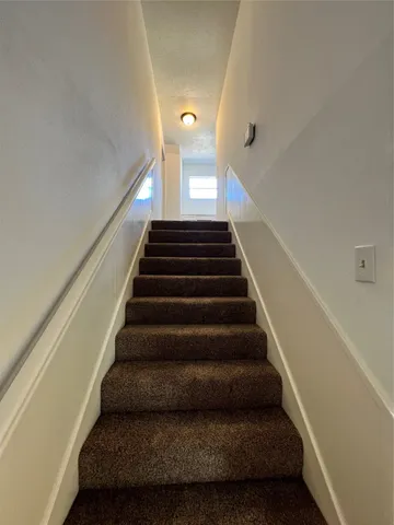 a kitchen with granite countertop a sink and a stove top oven