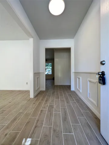 wooden floor in an empty room with a window