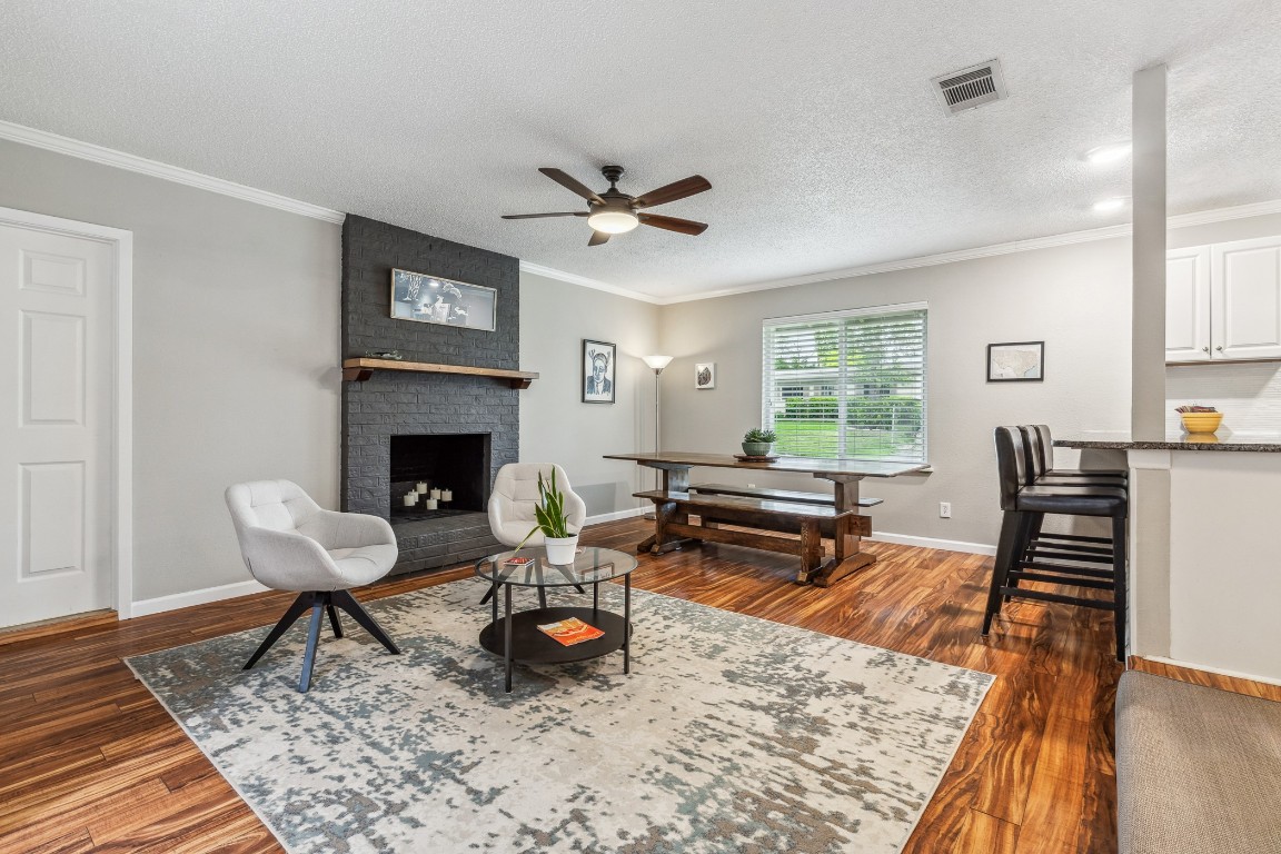 a living room with furniture a rug and a fireplace
