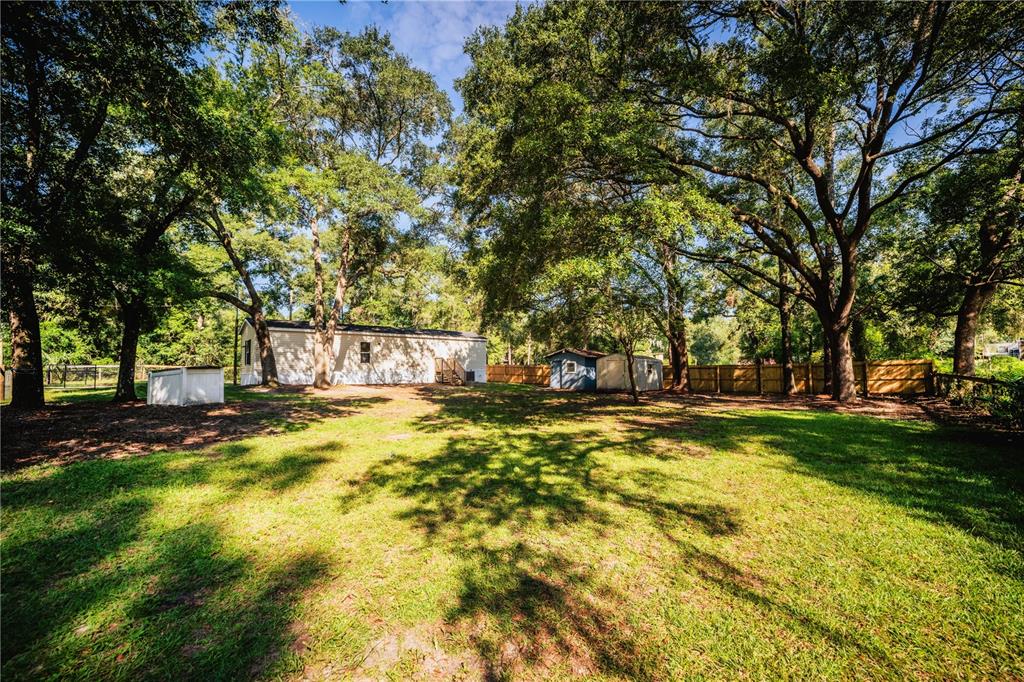 110 Possum Road Fort McCoy, FL 32134 - Photo 1 of 1 a view of yard with swimming pool and trees
