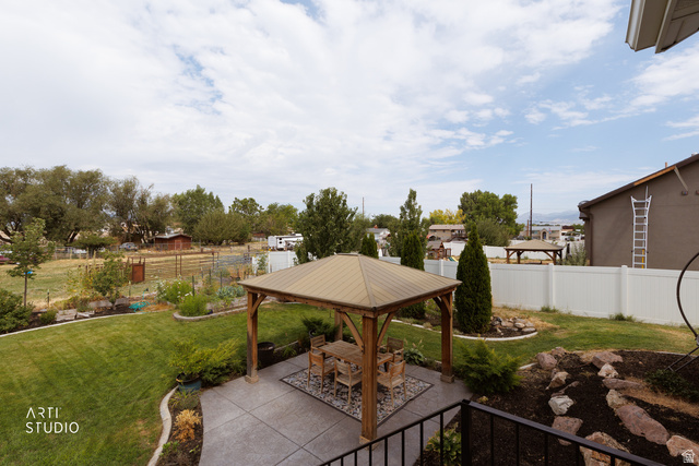 1654 South 730 West Provo, UT 84601 - Photo 28 of 33 Expansive backyard featuring a shaded patio with a wooden gazebo, a manicured lawn, tiered garden beds, and mature landscaping