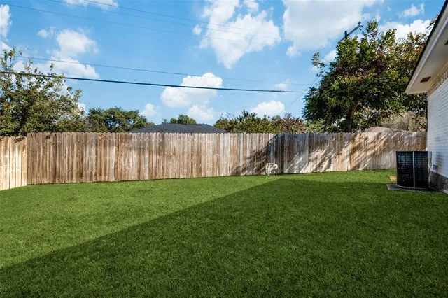 a view of a yard with a fence
