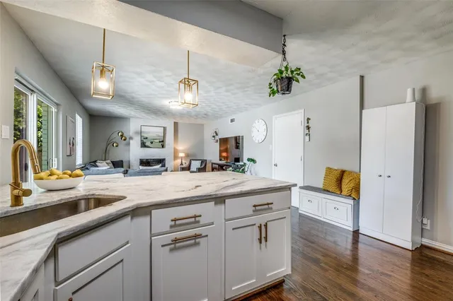 a kitchen with a sink a counter and cabinets