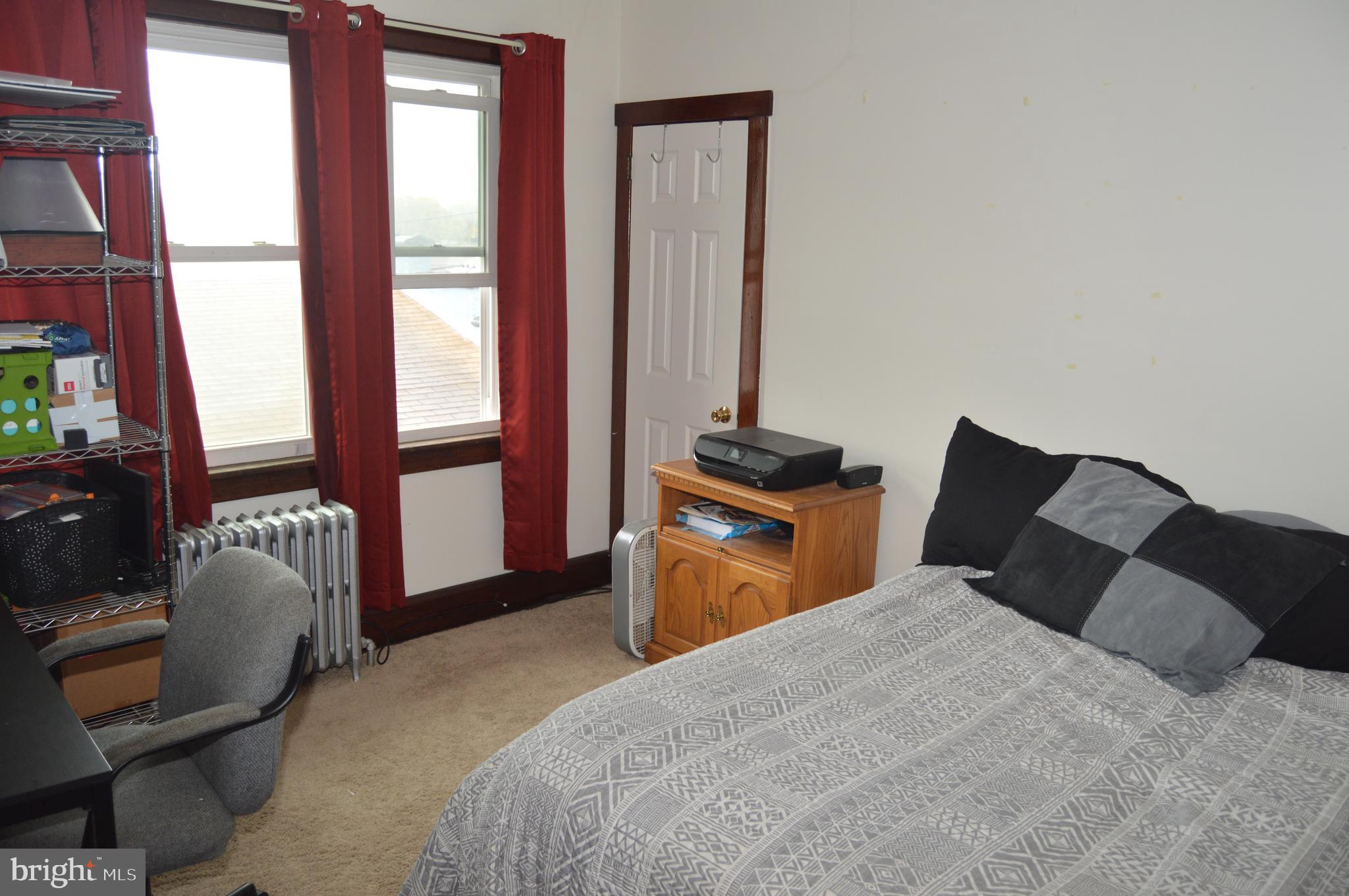 4715 Kutztown Road Temple, PA 19560 - Photo 14 of 28 a bedroom with a bed and a dresser next to a window