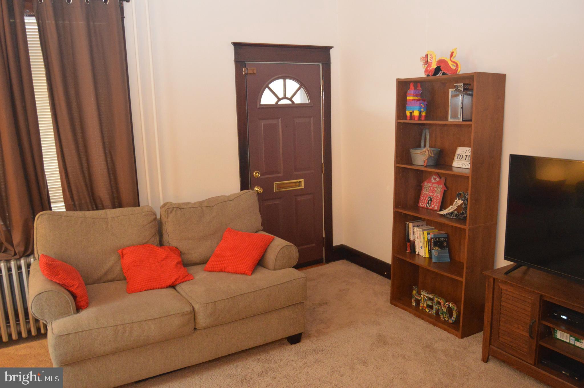 4715 Kutztown Road Temple, PA 19560 - Photo 3 of 28 a living room with furniture a flat screen tv and a window