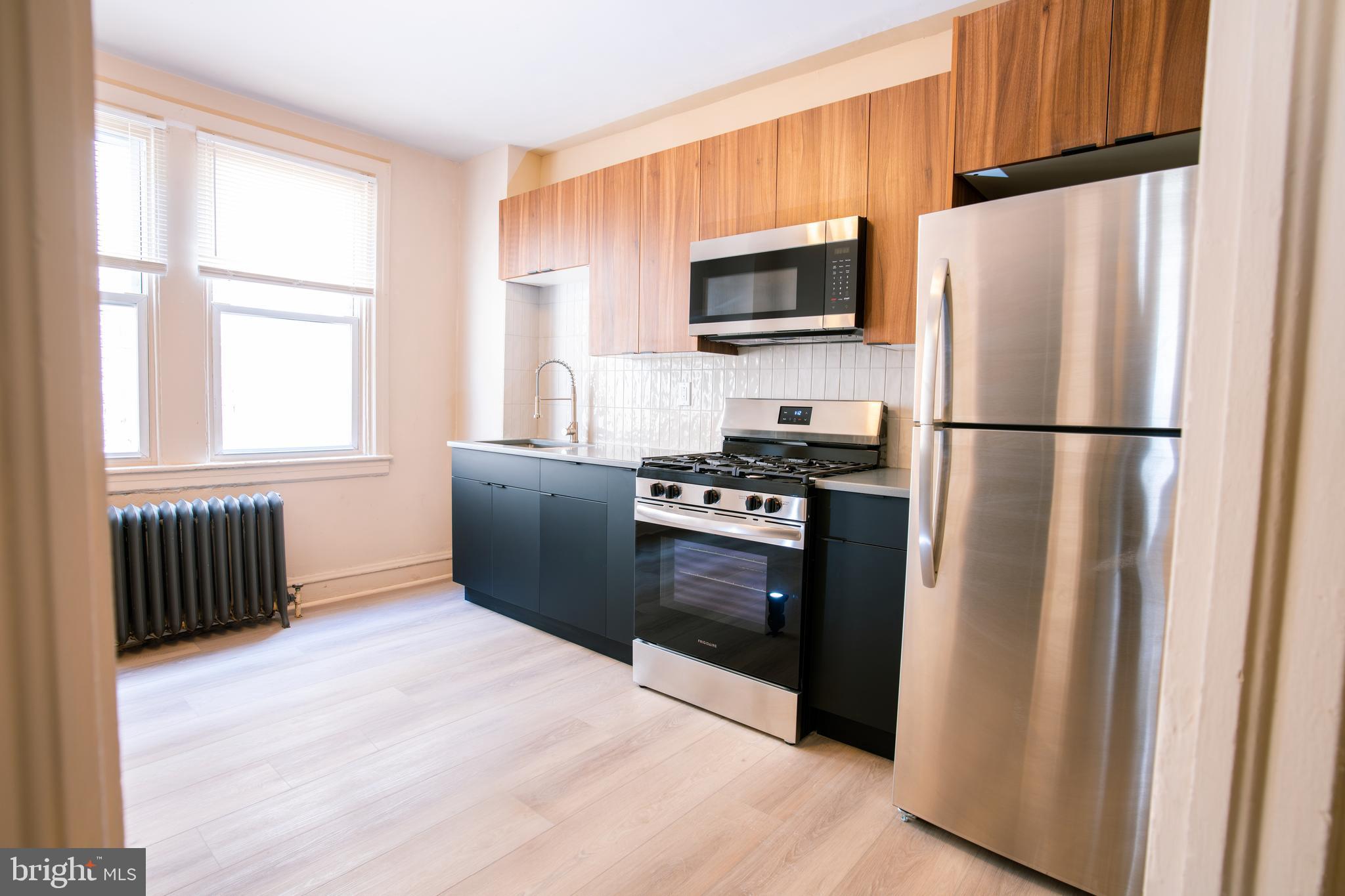 a kitchen with stainless steel appliances granite countertop a refrigerator stove a sink and dishwasher