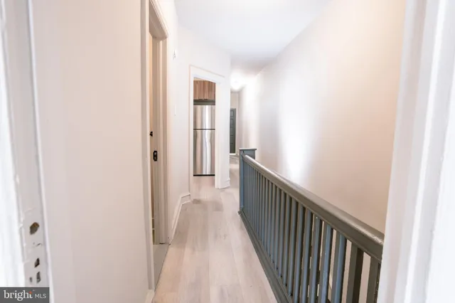 a view of a hallway with wooden floor