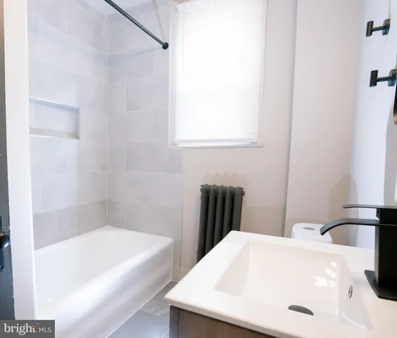 a bathroom with a bathtub and a sink