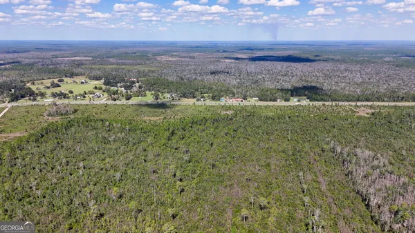 a view of a field with a mountain in the background