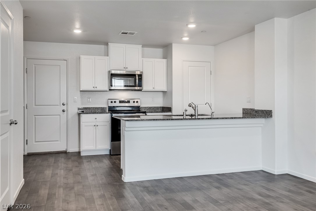 1114 Scarlet Sparrow Street Henderson, NV 89011 - Photo 9 of 25 A well-appointed kitchen features ample counter space and modern appliances.