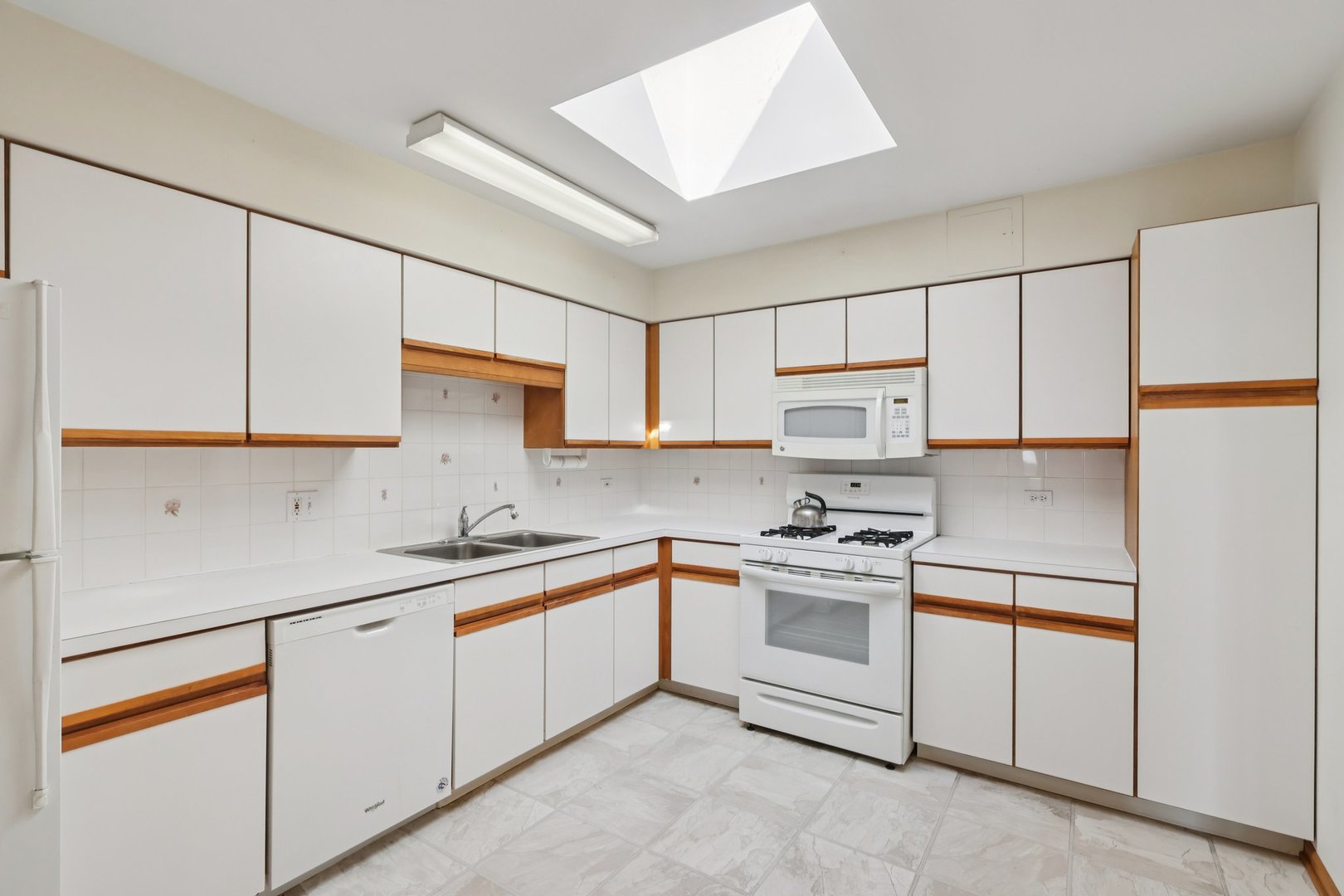 7450 North Waukegan Road, Unit 505 Niles, IL 60714 - Photo 12 of 30 a kitchen with stainless steel appliances granite countertop white cabinets a sink and a stove