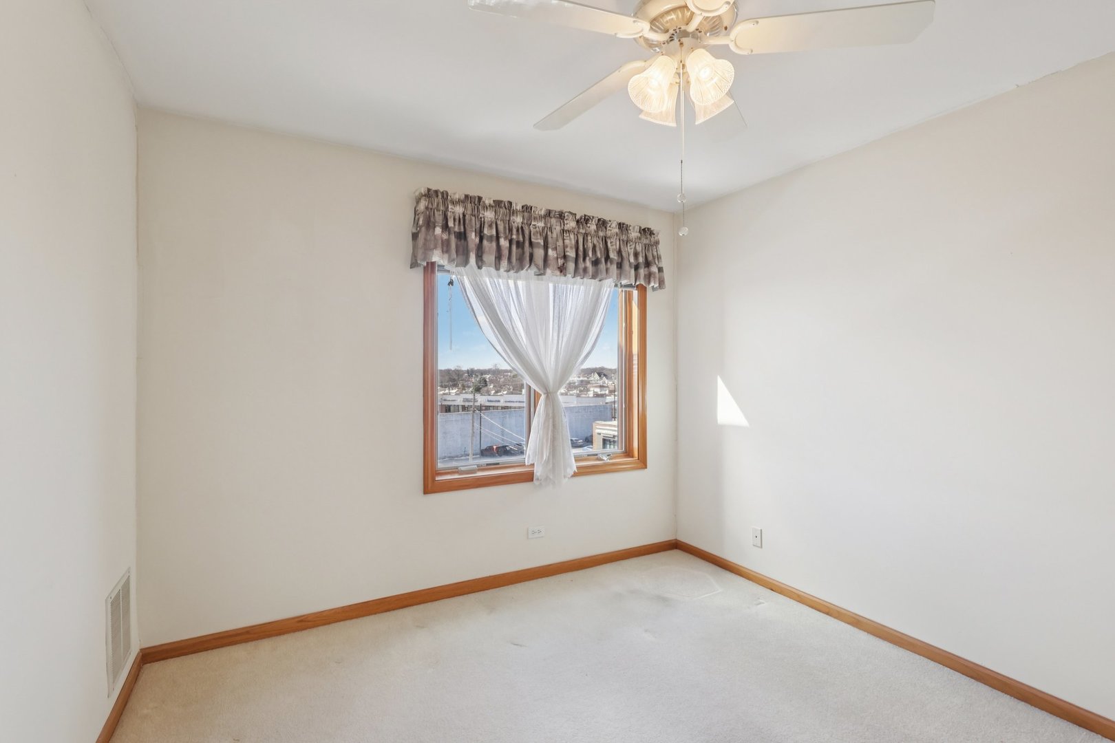 7450 North Waukegan Road, Unit 505 Niles, IL 60714 - Photo 14 of 30 an empty room with windows and fan