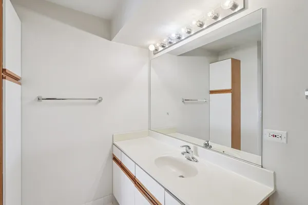 a bathroom with a double vanity sink toilet and a mirror
