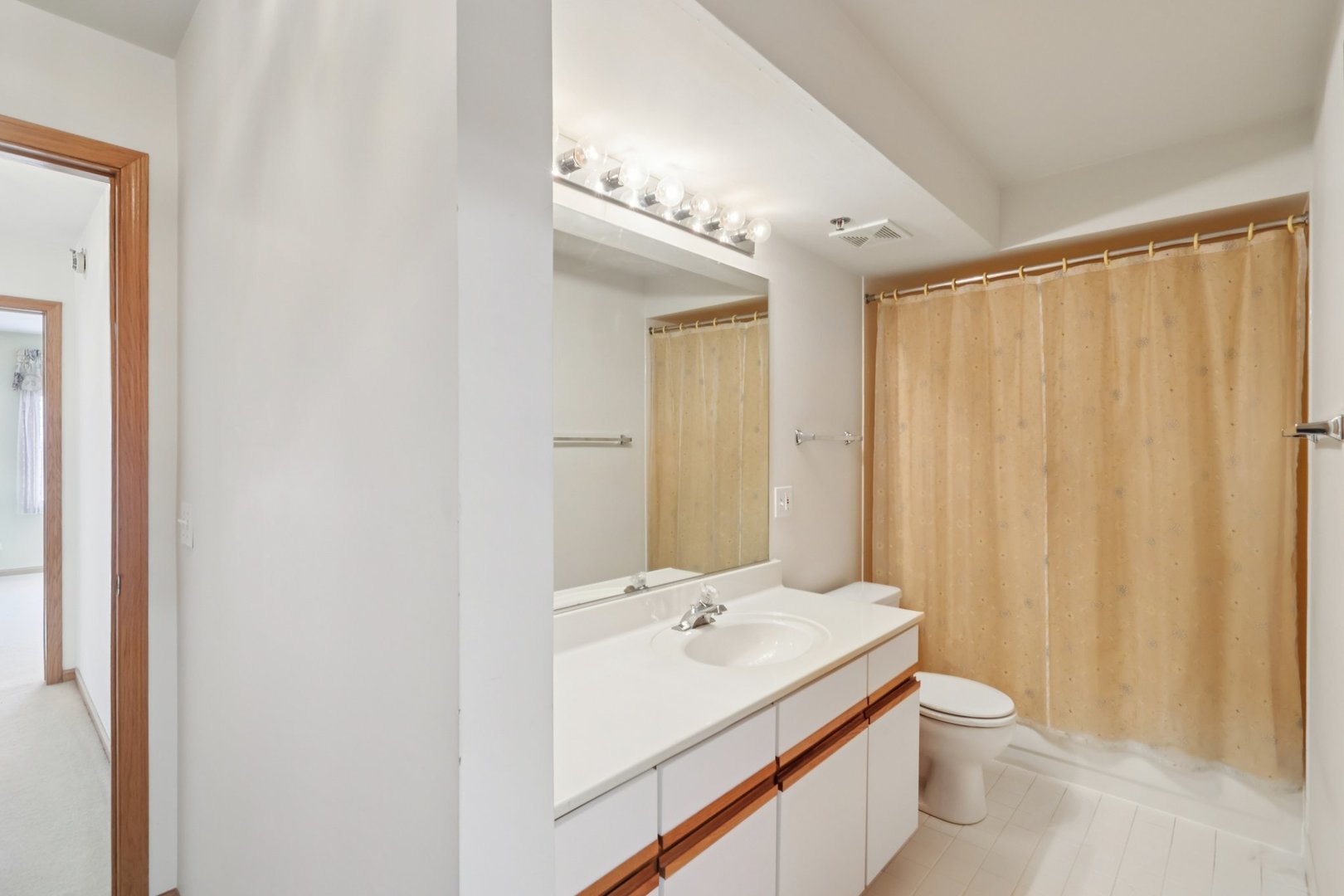 7450 North Waukegan Road, Unit 505 Niles, IL 60714 - Photo 22 of 30 a bathroom with a double vanity sink toilet and a mirror