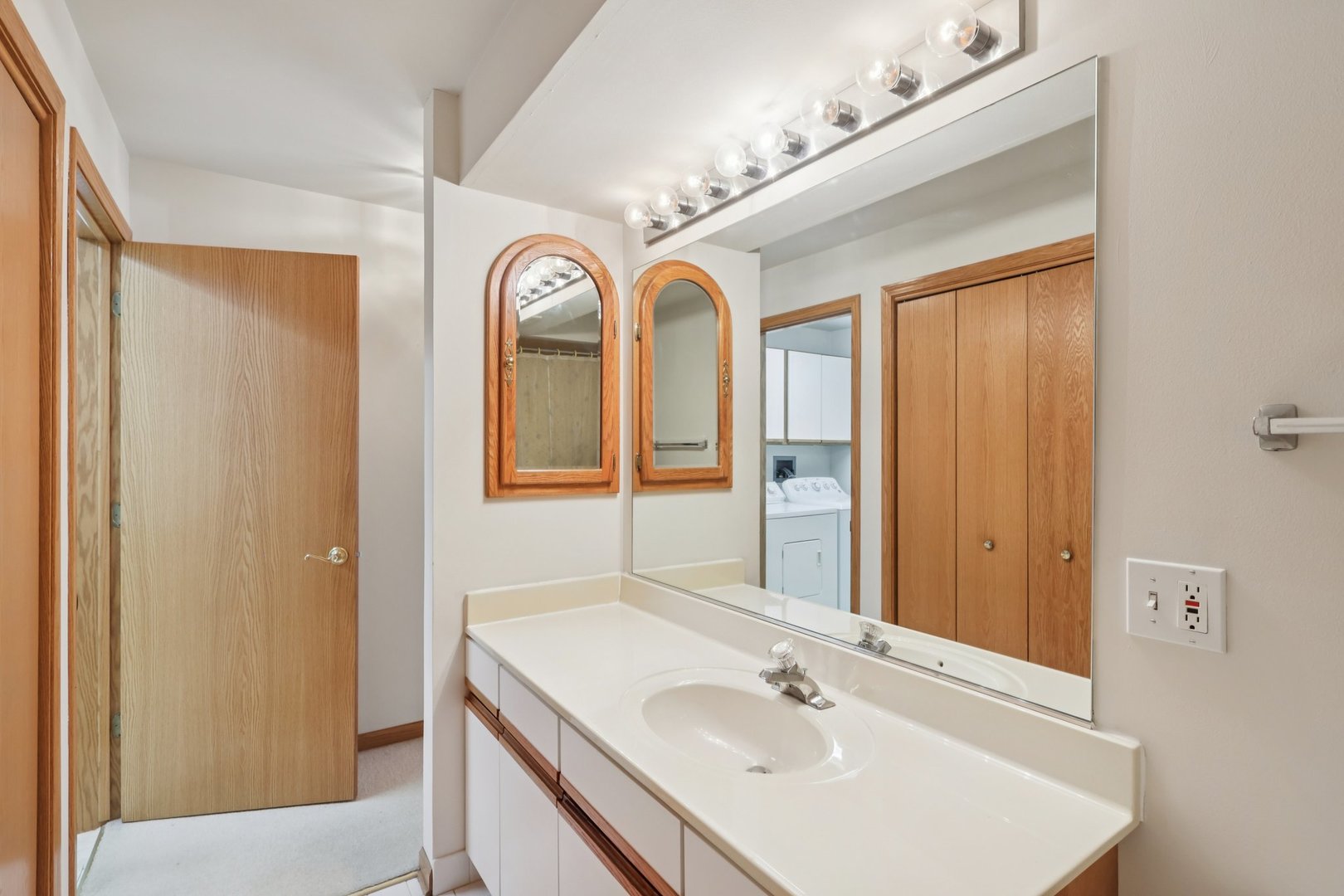 7450 North Waukegan Road, Unit 505 Niles, IL 60714 - Photo 23 of 30 a bathroom with a sink and a mirror