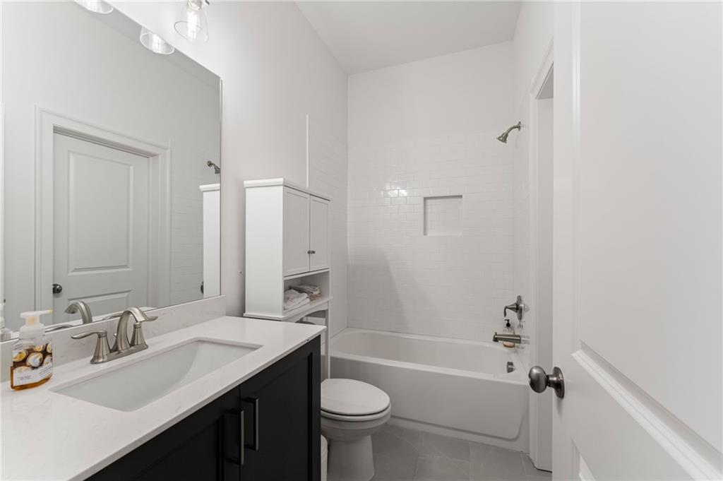 7170 Lullwater Road Cumming, GA 30040 - Photo 60 of 86 a bathroom with a sink a toilet and shower