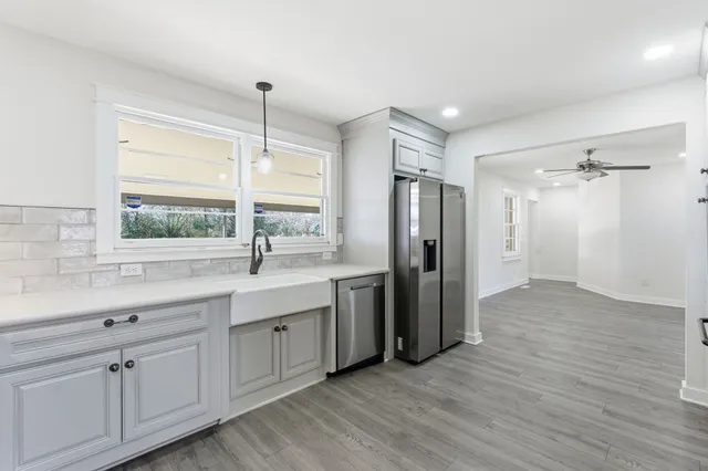 a kitchen with stainless steel appliances granite countertop a sink stove and refrigerator