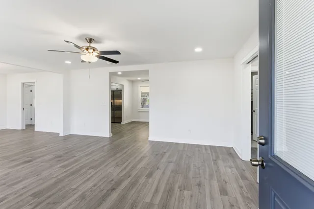 a view of empty room with wooden floor