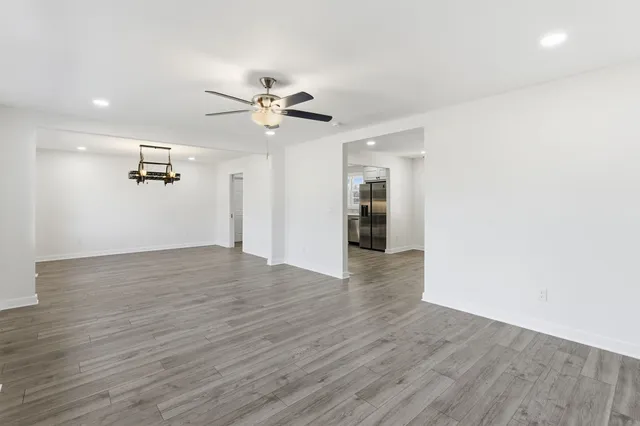 a view of empty room with wooden floor