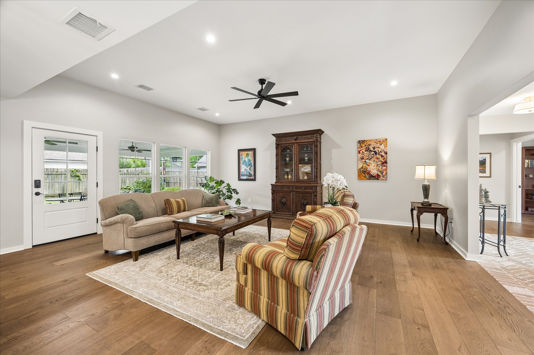 1059 Candlelight Lane Houston, TX 77018 - Photo 13 of 35 a living room with furniture ceiling fan and a wooden floor