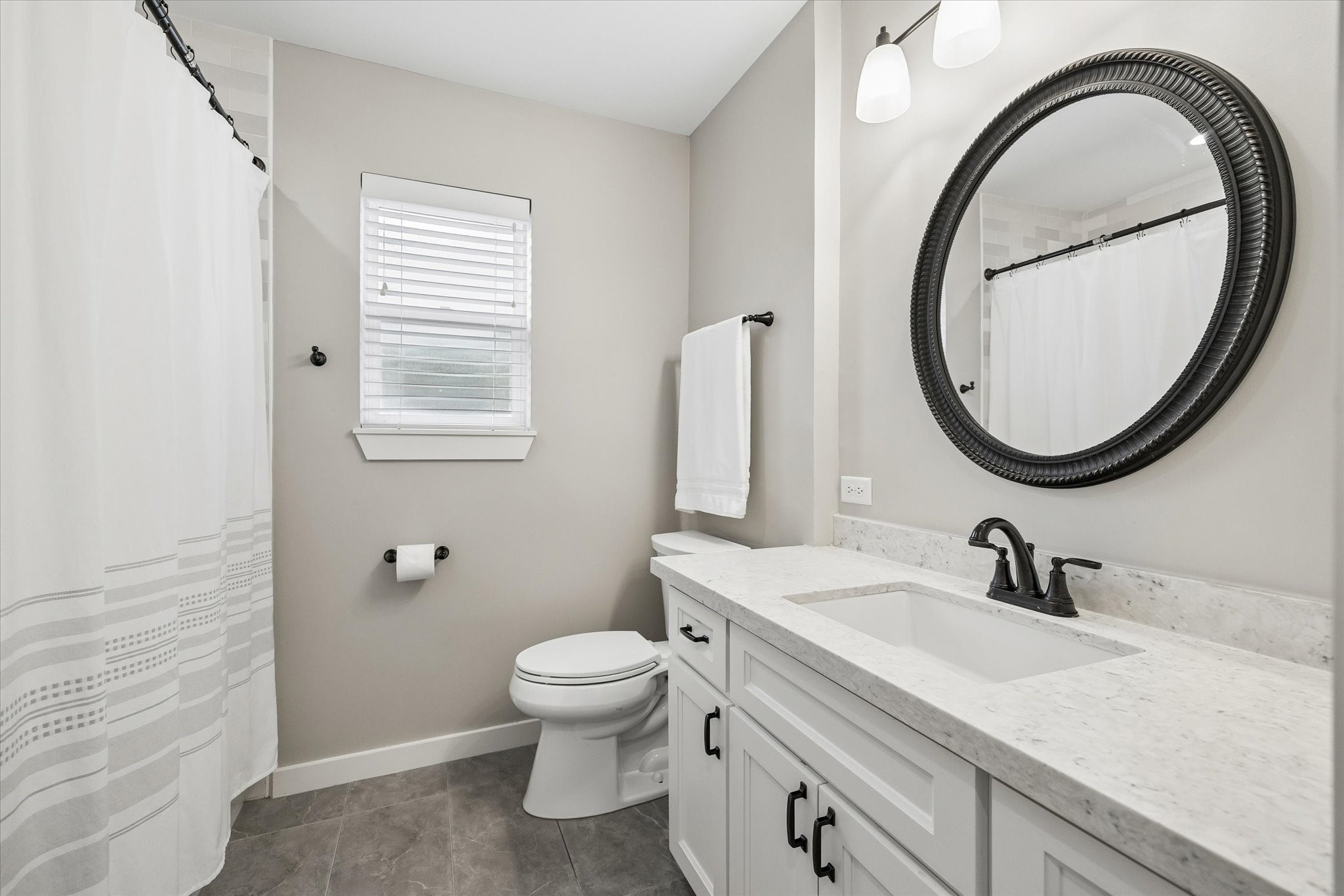 1059 Candlelight Lane Houston, TX 77018 - Photo 20 of 35 a bathroom with a sink a toilet and a mirror