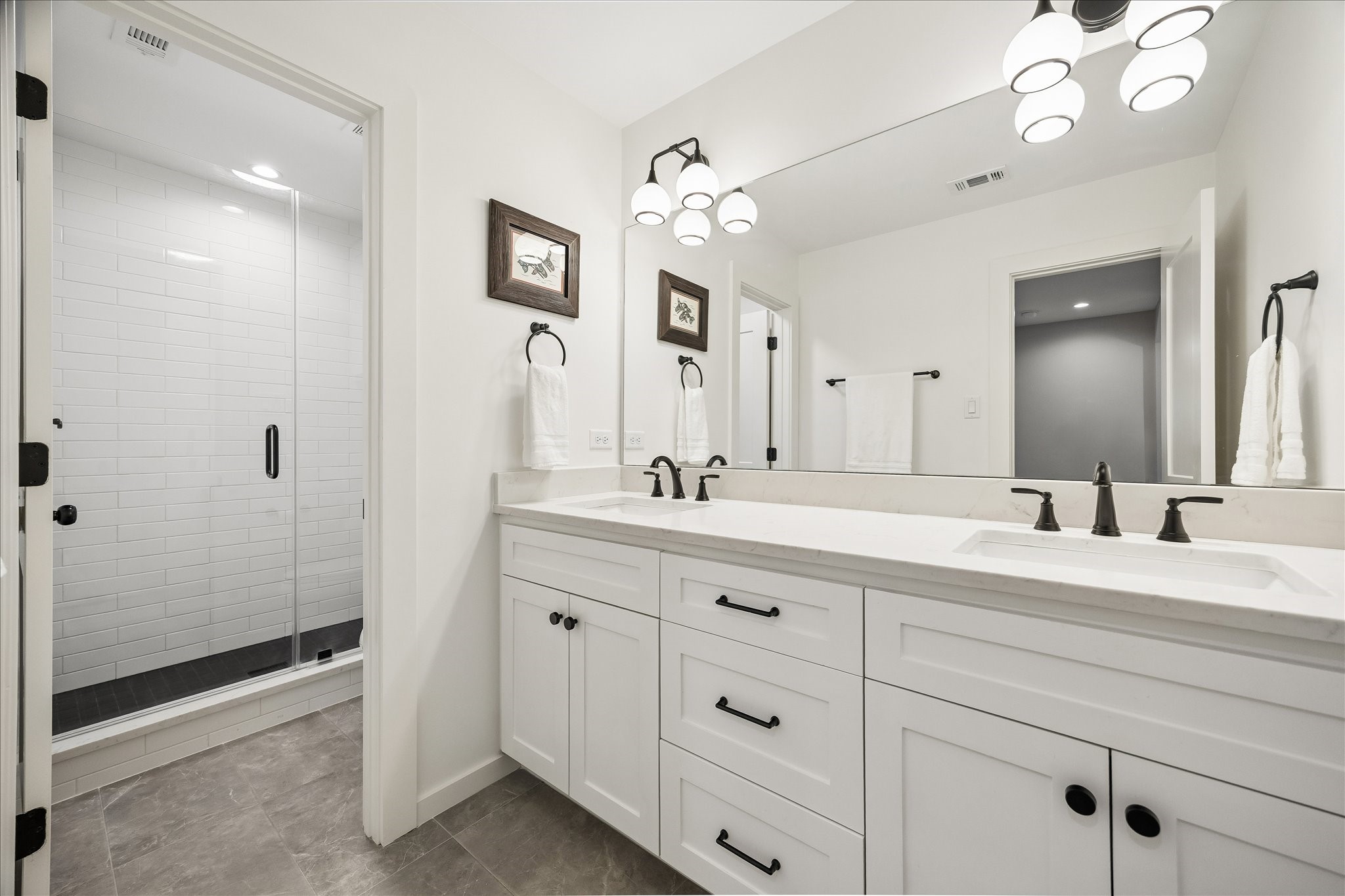 1059 Candlelight Lane Houston, TX 77018 - Photo 26 of 35 a spacious bathroom with a granite countertop sink a mirror and a shower