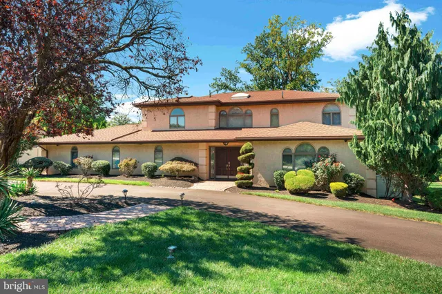 a front view of a house with yard and porch