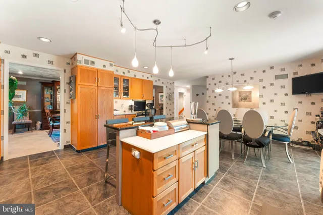 a open kitchen with stainless steel appliances kitchen island granite countertop a sink and cabinets