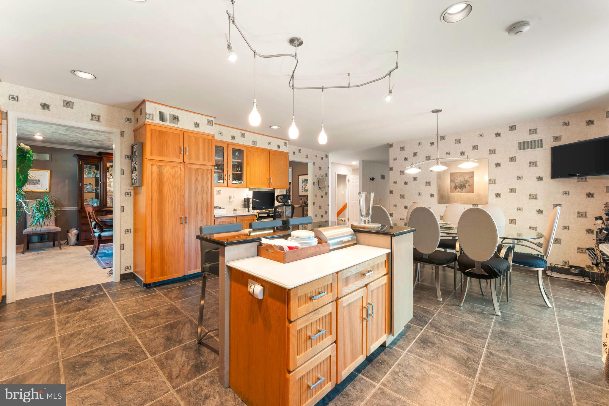 3843 Loop Road Huntingdon Valley, PA 19006 - Photo 14 of 51 a open kitchen with stainless steel appliances kitchen island granite countertop a sink and cabinets