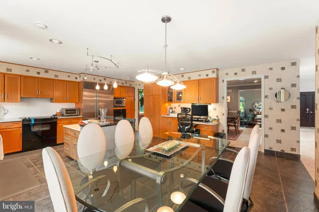 a living room with furniture a chandelier and fireplace