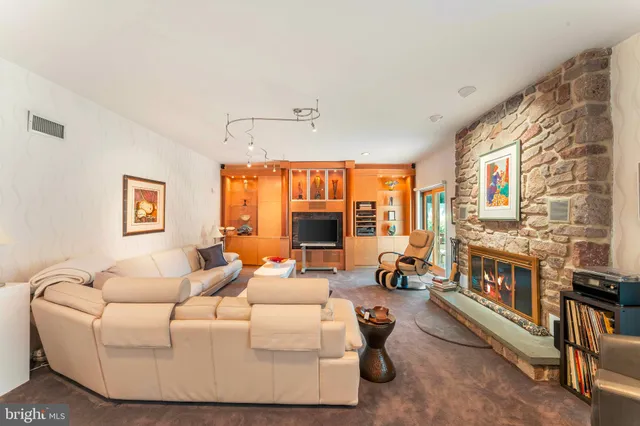 a living room with fireplace furniture and a large window