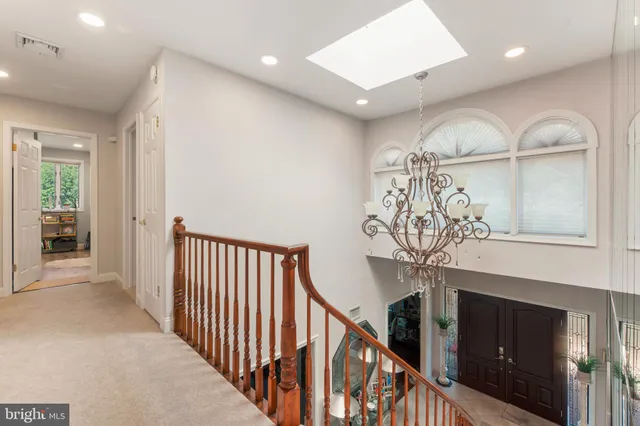 a view of a livingroom with wooden floor and staircase