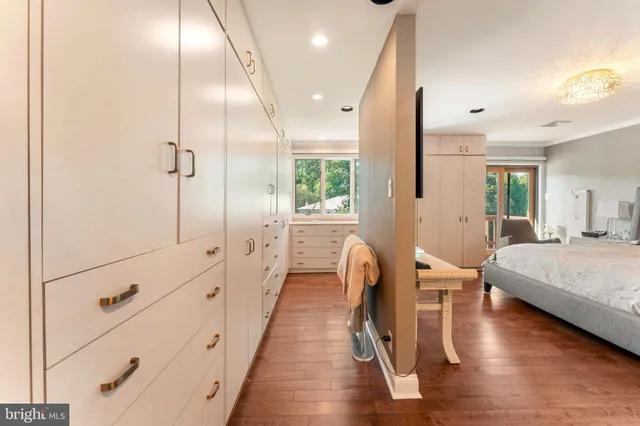 a bathroom with a bathtub a double vanity sink and mirror