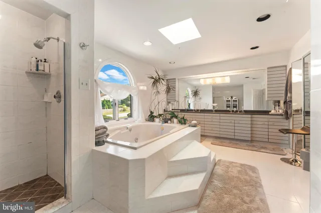 a bedroom with a bed couch and window