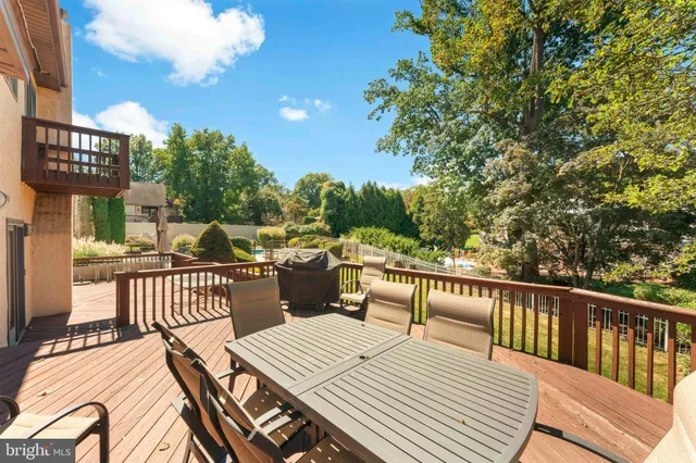 a view of a patio with a dining table and chairs with wooden floor