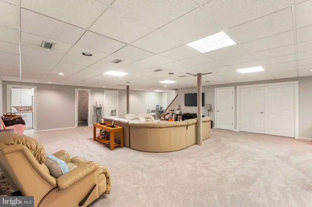 a bathroom with a granite countertop toilet a sink and a mirror