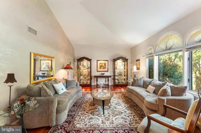 a living room with furniture large window and table