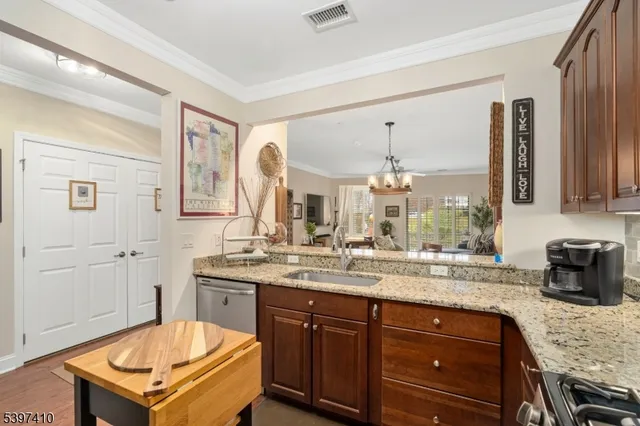 a bathroom with a granite countertop sink a mirror and a bathtub