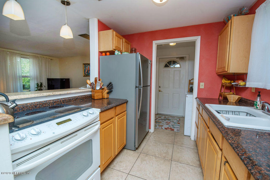 843 Viscaya Boulevard St. Augustine, FL 32086 - Photo 12 of 33 a kitchen with stainless steel appliances granite countertop a sink and a refrigerator