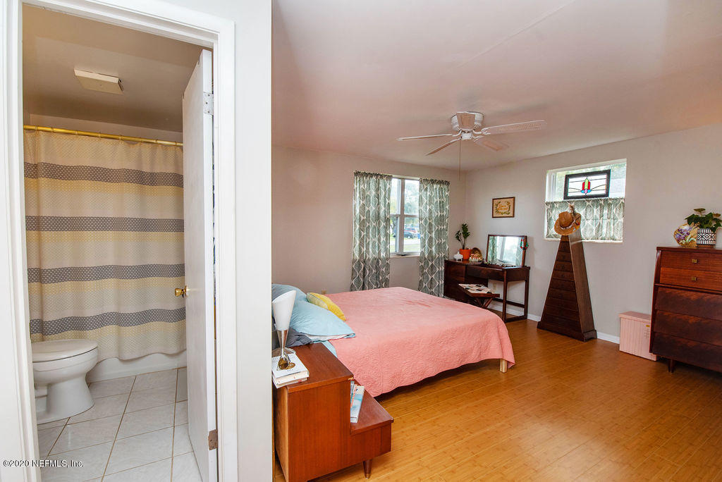 843 Viscaya Boulevard St. Augustine, FL 32086 - Photo 18 of 33 a bedroom with a bed and wooden floor