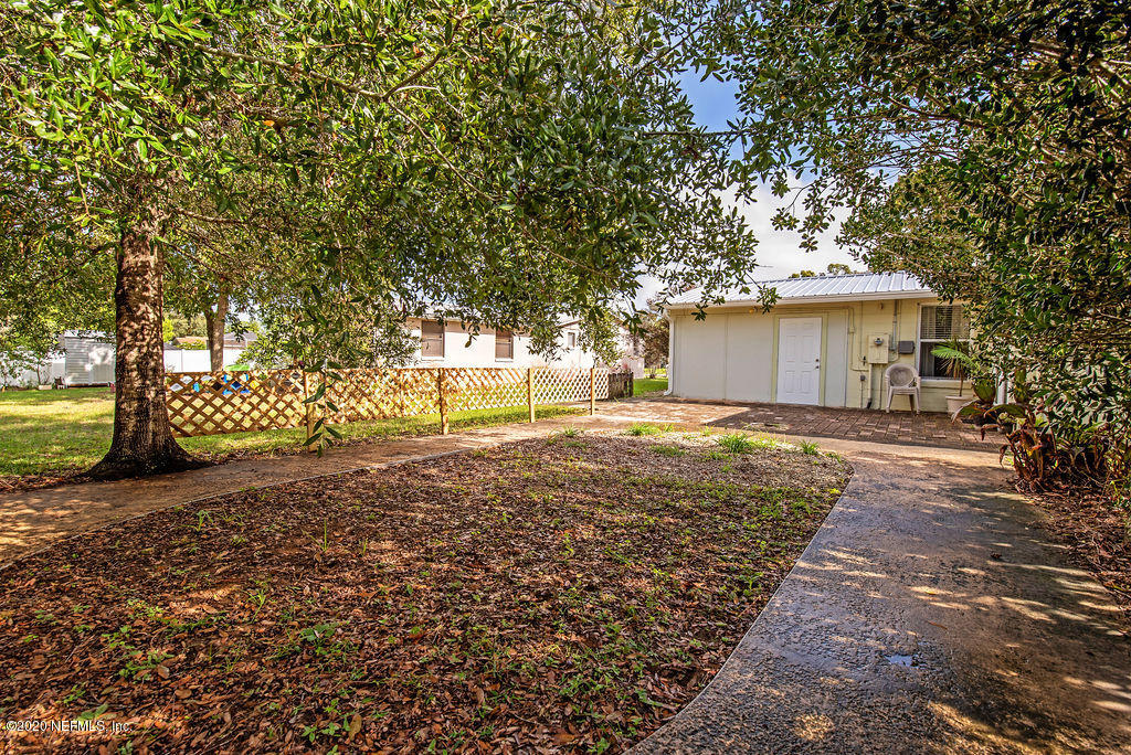 843 Viscaya Boulevard St. Augustine, FL 32086 - Photo 24 of 33 a view of a yard with plants and large trees