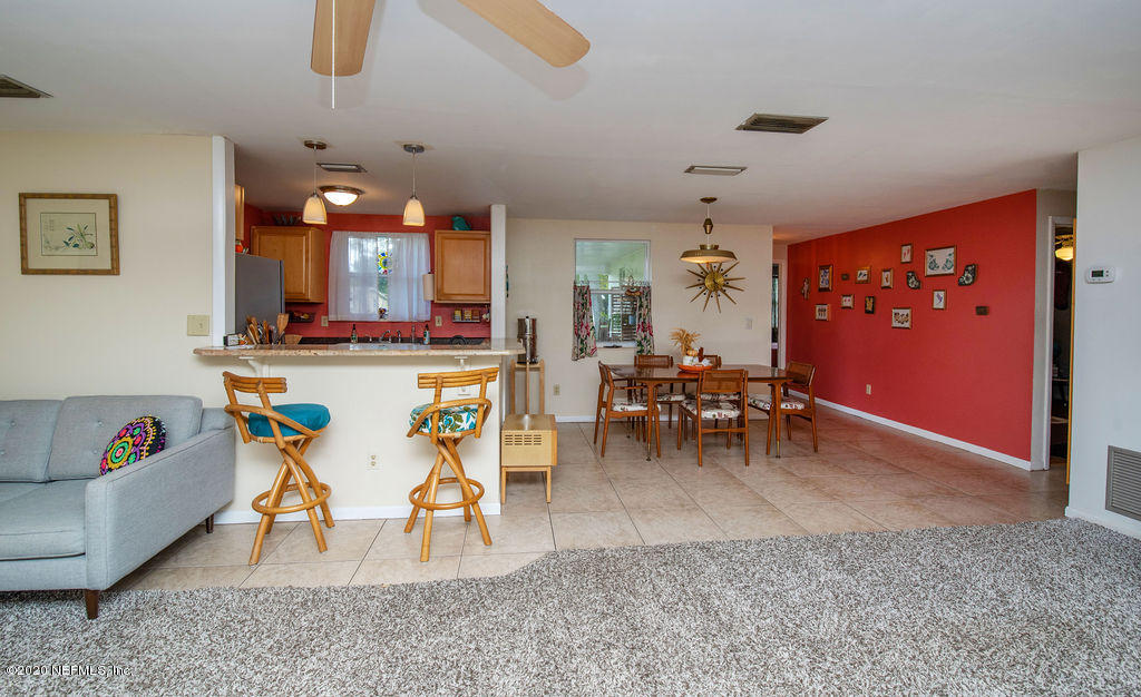 843 Viscaya Boulevard St. Augustine, FL 32086 - Photo 10 of 33 a living room with furniture a dining table and kitchen view