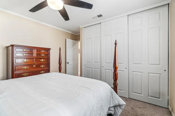 a bedroom with a bed and a lamp on table