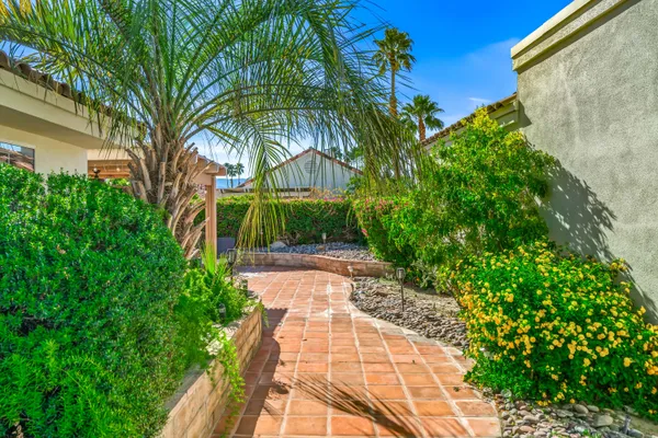 a view of a garden with a building in the background