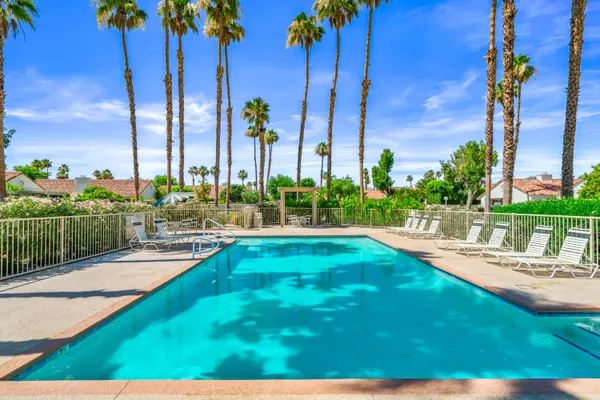 a view of swimming pool with seating area and furniture