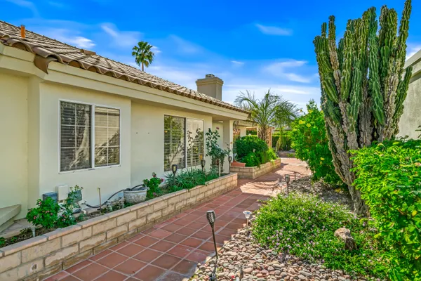 a view of a house with a flower garden